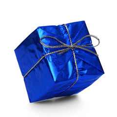 Blue gift with a silver ribbon and a bow falling on white backgr