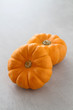 Two small decorative pumpkins