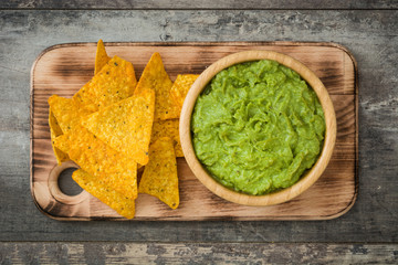 Wall Mural - Nachos and  guacamole on wooden background

