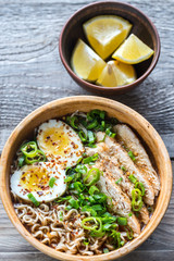 Wall Mural - Bowl of chicken ramen soup on the wooden table