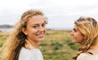 © Westend61 - Smiling blond teenage girl and her best friend at the coast