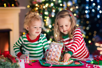 Kids making Christmas ginger bread house