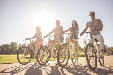 Friends cycling in park