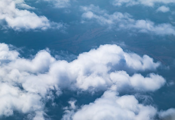 Wall Mural - Aerial view of cloud and sky from airplane window looking down t