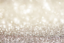 Silver White Glittering Christmas Lights. Festive Abstract Glitter Bokeh Background