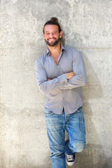 Handsome man smiling with arms crossed