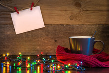 Christmas Background With Cup Wrapped In Red Scarf And Lights On