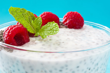 Wall Mural - Chia yogurt with raspberries on blue background

