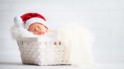 sleeper newborn baby in  Christmas Santa cap