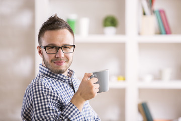 Poster - Male drinking coffee at workplace