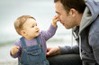 © scaliger - Playful one-year child touches his father's nose, baby and family concept