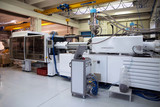 Fototapeta  - Injection molding machines in a large factory