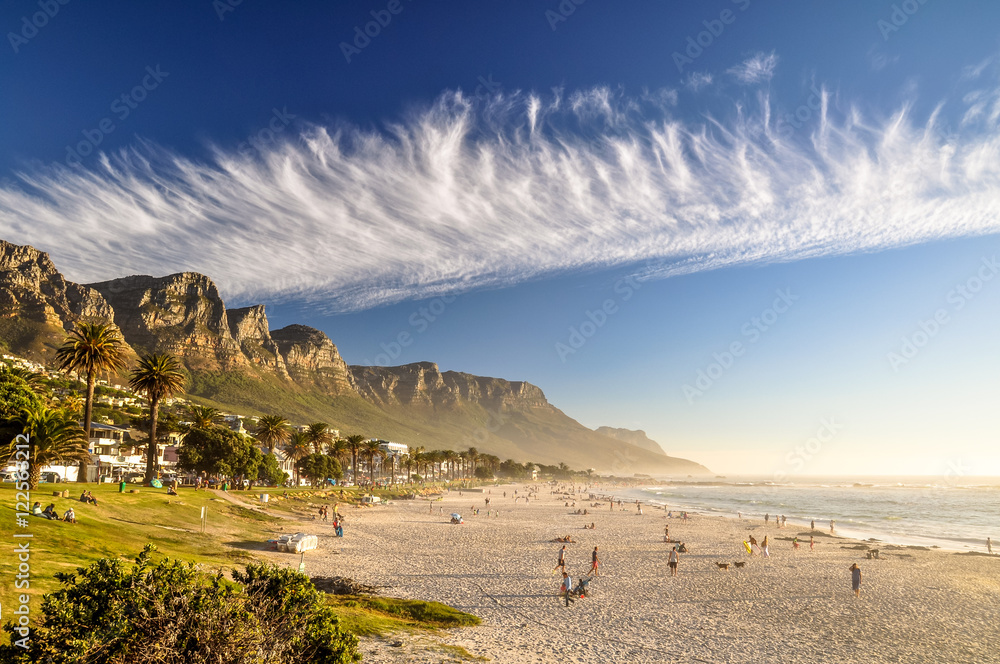 Stunning evening photo of Camps Bay, an affluent suburb of Cape Town, Western Cape, South Africa. With its white beach, Camps Bay attracts a large number of foreign visitors as well as South Africans. - obrazy, fototapety, plakaty 
