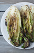 Grilled romaine lettuce on a  white plate 