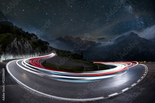 Photographie light trails on a hairpin bend and milky way in the background