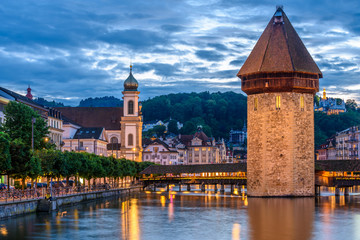 Night view towards Chapel Bridge (Kapellbruecke) together with the octagonal tall tower (Wasserturm) it is one of the Lucerne's most famous tourists attraction