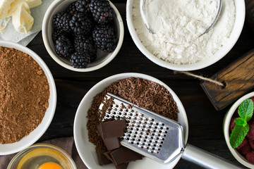 Poster - Baking chocolate dessert ingredients on dark wooden table
