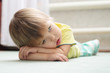 Little girl lying on the floor on arms