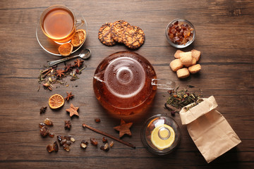 Poster - Ingredients for tea drinking on wooden background, flat lay