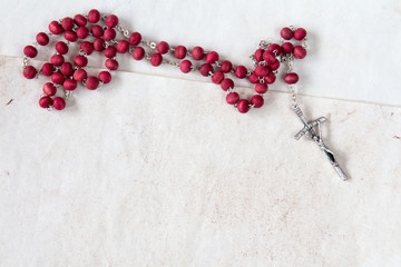 Wall Mural - Catholic rosary on old paper sheets.