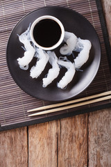 Wall Mural - Shirataki Noodles with soy sauce closeup on a plate. Vertical top view