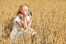 Woman Taking Picture With Camera In Cereal Field
