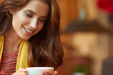 Canvas Print - Young beautiful woman in the cafe. Warm colors.