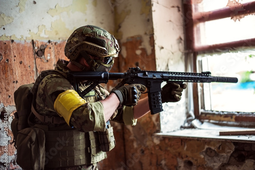 Cuadros en Lienzo sniper with automatic rifle by the window in building