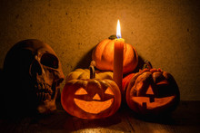 Jack O' Lantern At Night, Pumpkins And Skull With Candle Light In The Dark Night / Still Life And Dark Image.