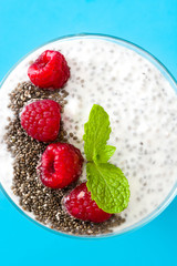 Wall Mural - Chia yogurt with raspberries on blue background

