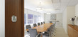 © Adrian Wilson - Table and chairs in empty conference room
