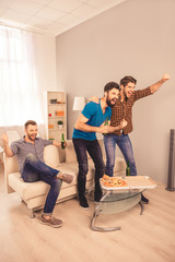 Canvas Print - Three excited man celebrating football victory with beer and piz