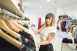 © FotoAndalucia - Young latin girl is doing shopping in the showroom.