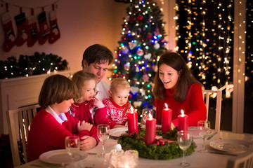 Wall Mural - Family having Christmas dinner at fire place