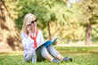 © sepy - Working outside. Full lenght portrait of beautiful smiling businesswoman making call while sitting outdoor in coffee break.