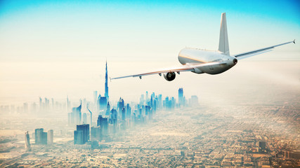 Commercial airplane flying over modern city