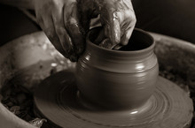 Potter Shaping Clay On The Pottery Wheel