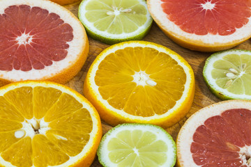 Wall Mural - Citrus fruit background with sliced f oranges lemons lime tanger