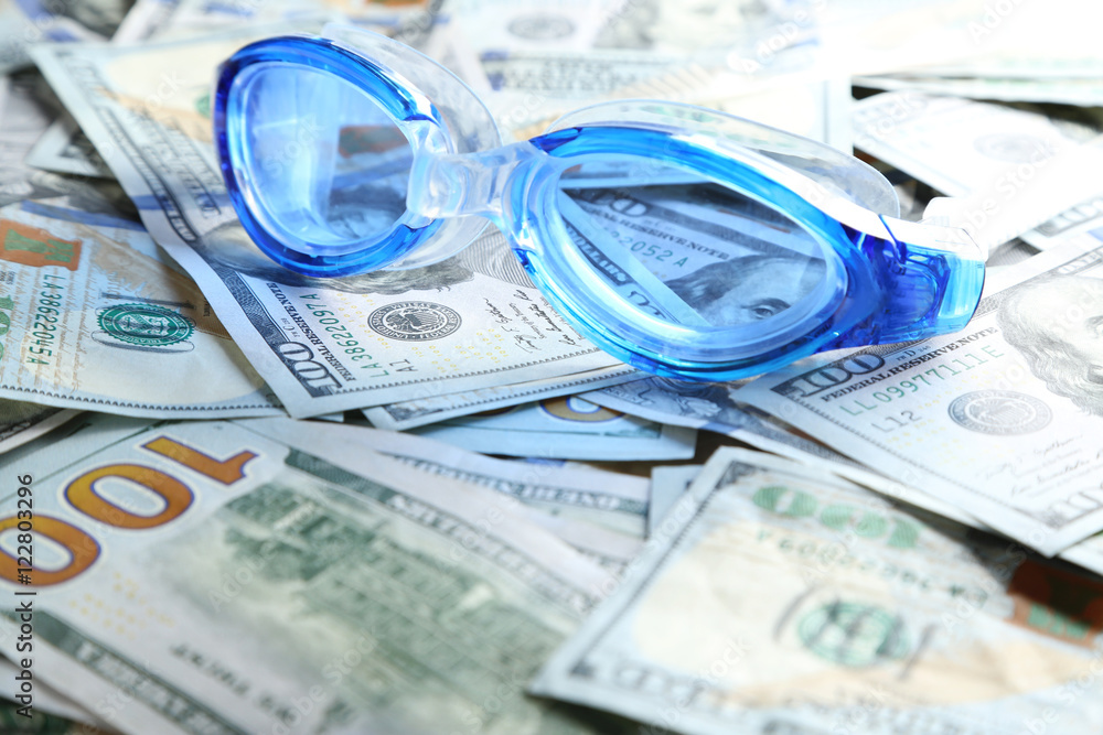 Swimming goggles  on money bills
