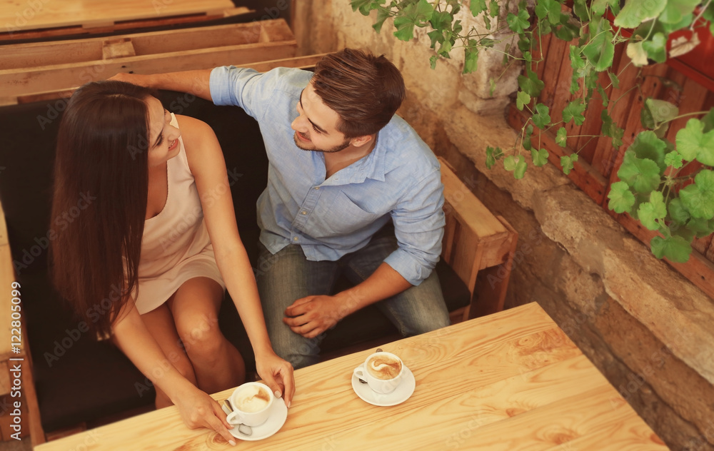 Beautiful young couple drinking coffee on date