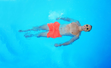 Wall Mural - Handsome man relaxing in swimming pool