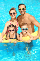 Wall Mural - Happy family in swimming pool at water park