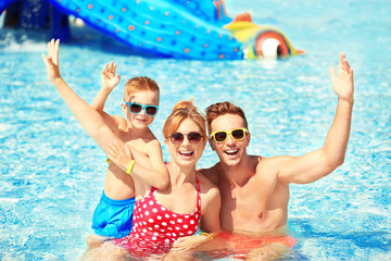 Canvas Print - Happy family in swimming pool at water park