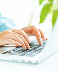 woman office worker typing on the keyboard