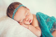 Sleeping newborn baby on a blanket