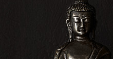 Traditional Bronze Buddha Statue Isolated On Black Background.