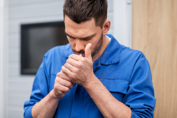 Sticker - auto mechanic smoking cigarette at car workshop