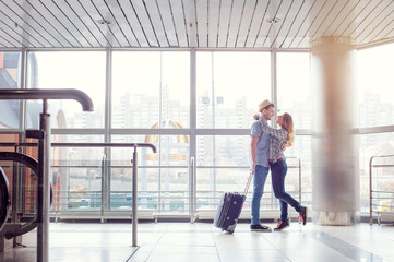 Welcoming embrace. Young loving couple hugging in the airport terminal.