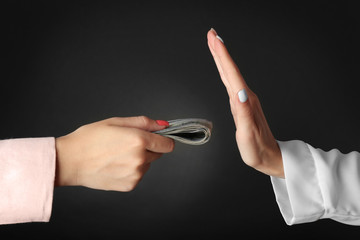 Canvas Print - Corruption concept. Female hands with money on black background