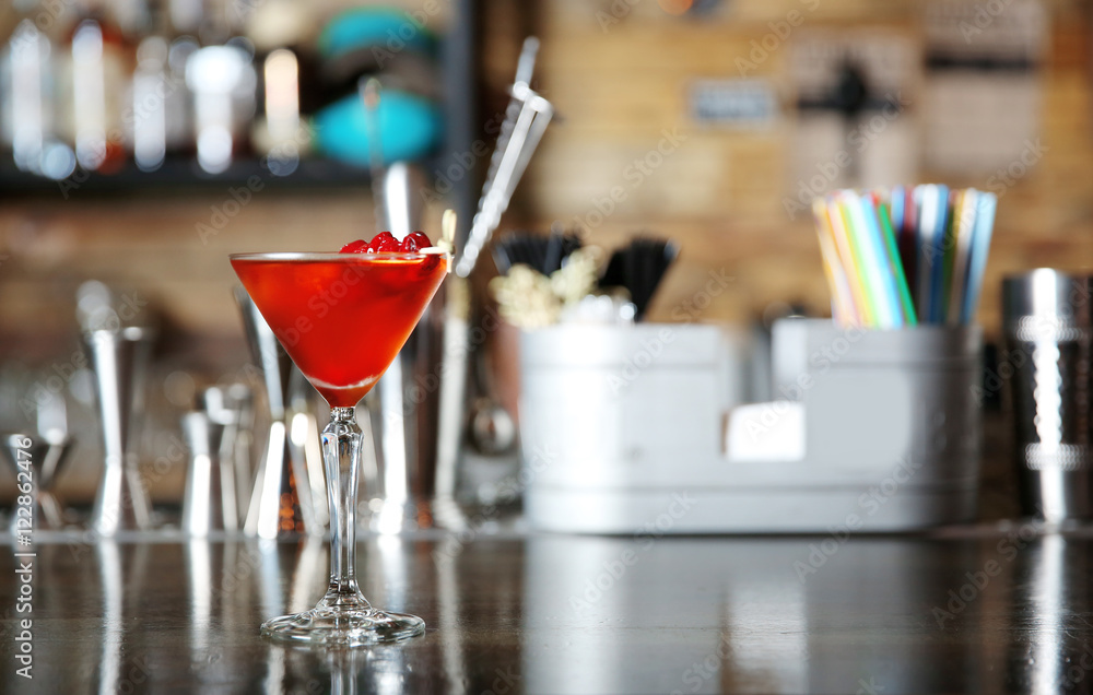 Tasty cocktail on wooden table in bar